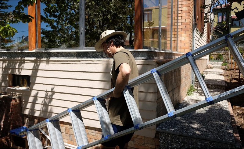 Home Contractor with Large Metal Ladder