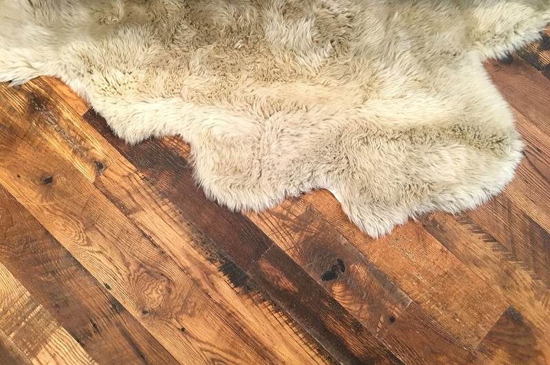 Hardwood Floor with Sheepskin Rug with minor scratches and scuffs