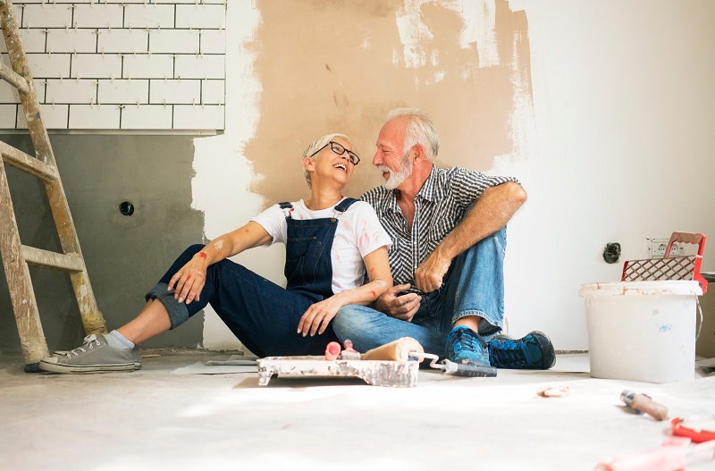 Elderly Couple Laughing About Home Remodeling Project