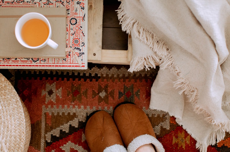 Cozy Warm Home with Blanket, Slippers, Hot Tea and Wool Rug