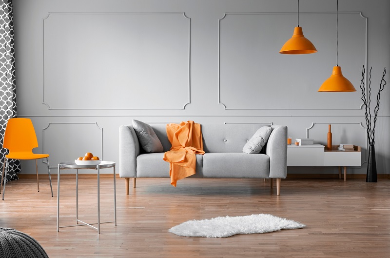 Gray Walled Living Room with Orange Accent Pieces