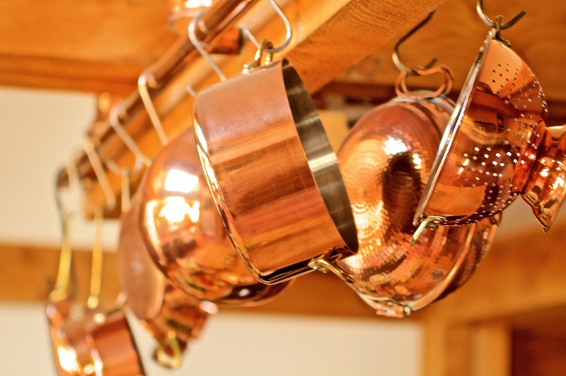 Hanging copper pots and colander in kitchen