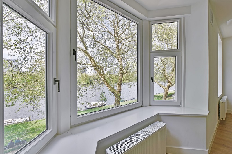 Large bay window in empty home with view of river