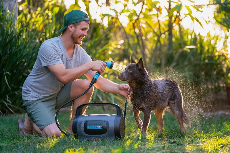RinseKit for Pets, dog being watered down outside