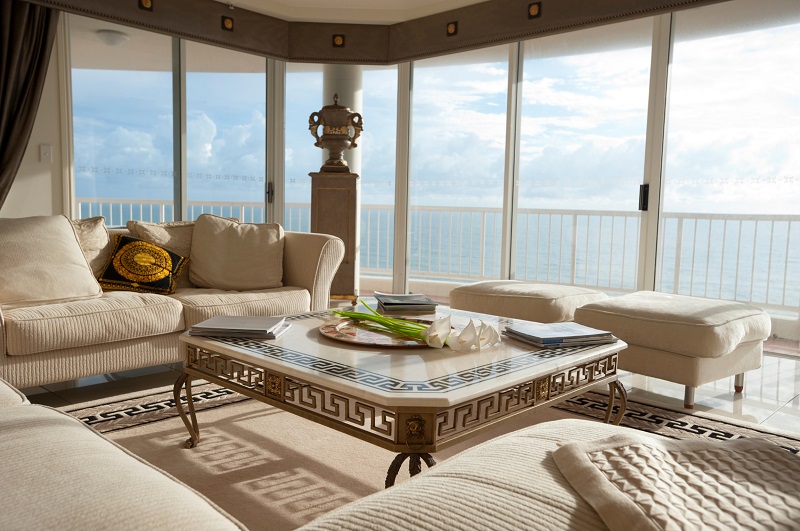 Ornate square coffee table in living room with ocean views