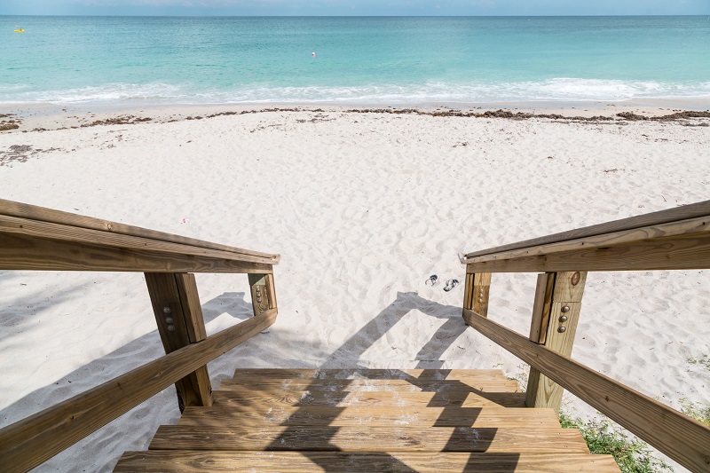 Wooden steps leading to white sandy beach