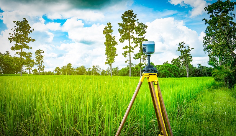 GPS surveying equipment on a piece of private rural land during summer