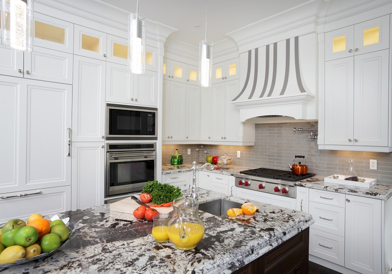Luxury white kitchen with tall cabinets with crown molding