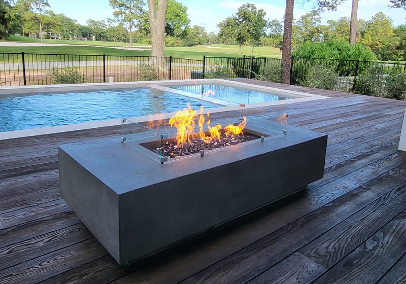 Millboard pool deck with fire pit