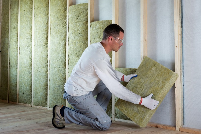 Contractor installing Rock Wool mineral wool insulation