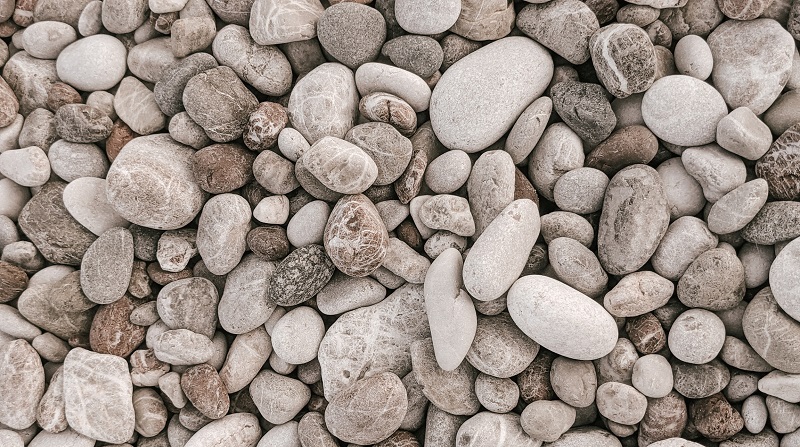 Color psychology: neutral colors found in nature - white, gray and beige stones on a beach