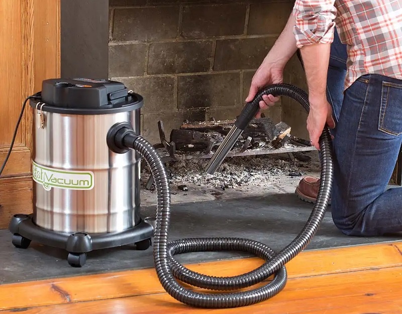 Ash vacuum in use. Model available from Plow & Hearth
