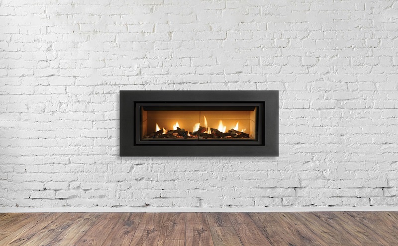 Modern gas fireplace in white brick wall