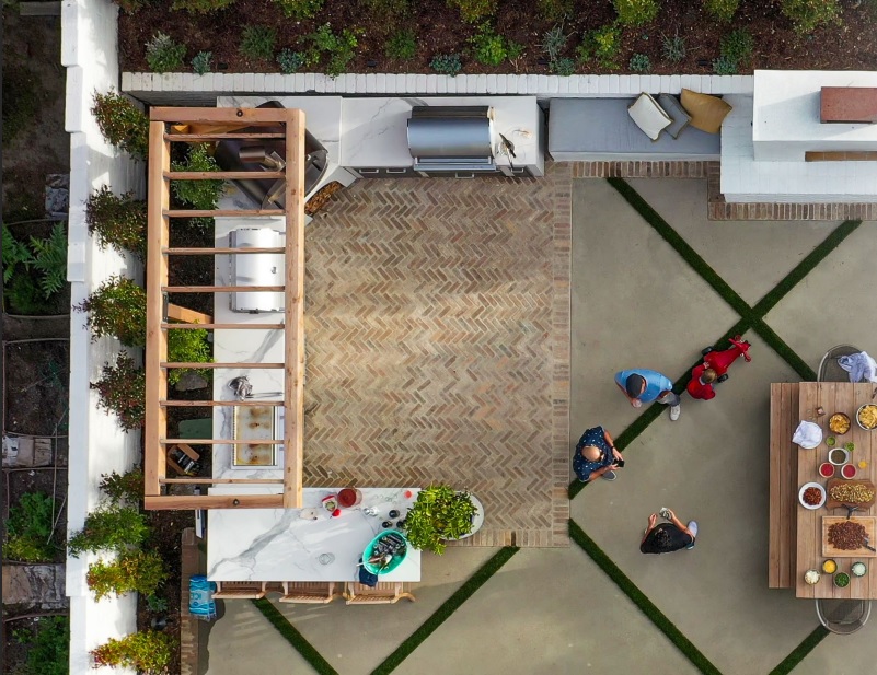 RTA Outdoor Living drone view above modular outdoor kitchen and patio, with guests