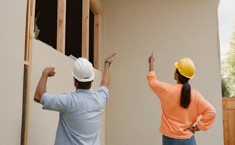 Homeowner giving directions to home contractor during major home remodeling project