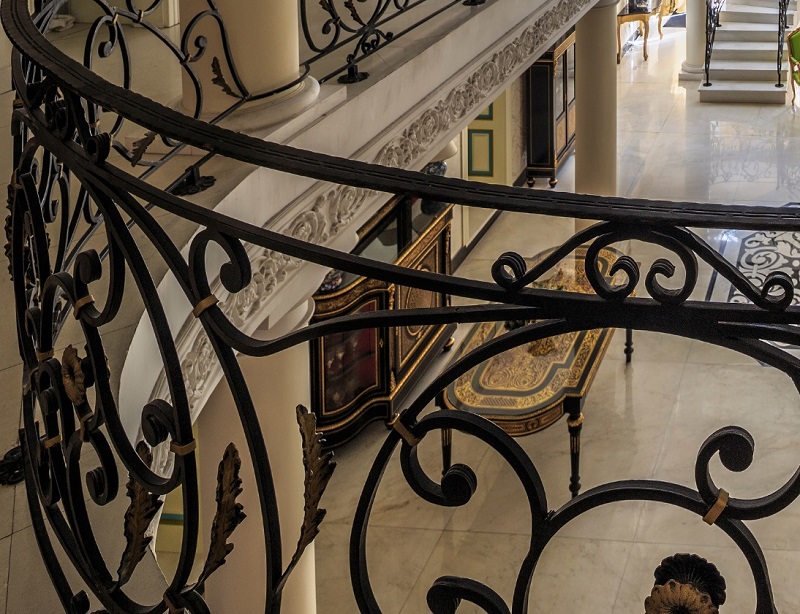 Interior wrought iron railing inside a converted Victorian mansion
