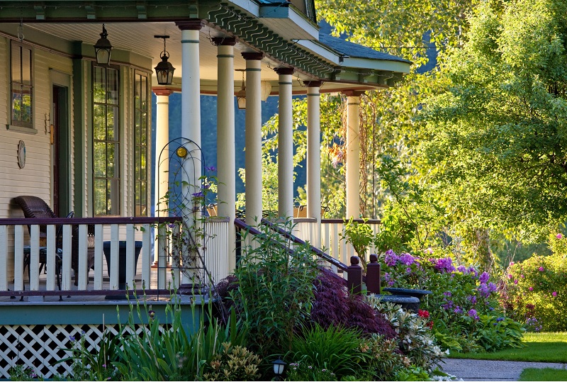 Large colorful front porch of a Victorian Home