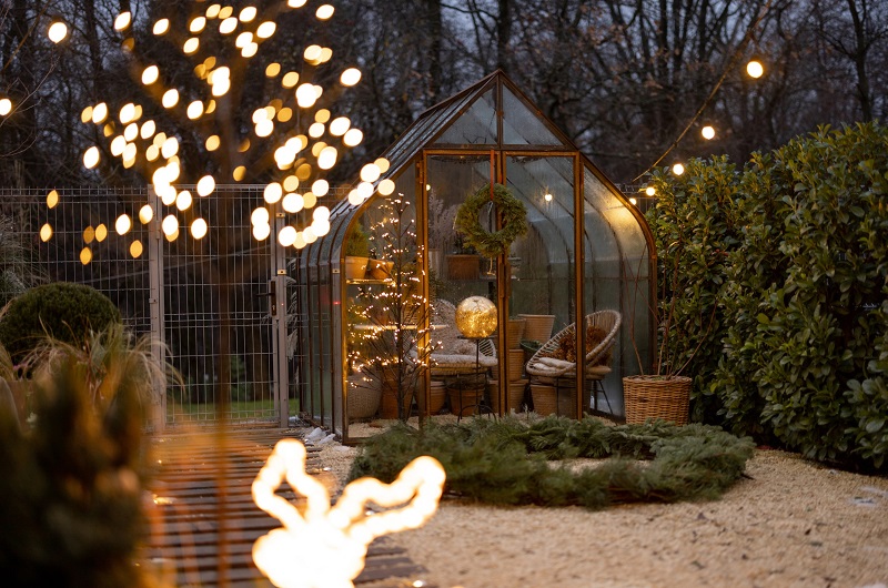 Backyard greenhouse converted to a sitting room with wintertime decor