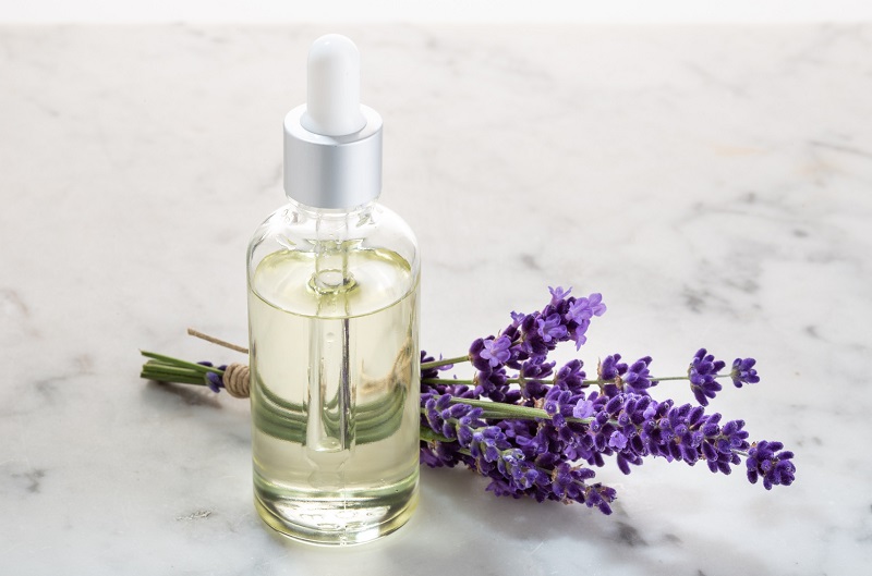 Lavender flowers and essential oil bottle for aromatherapy relaxation in home