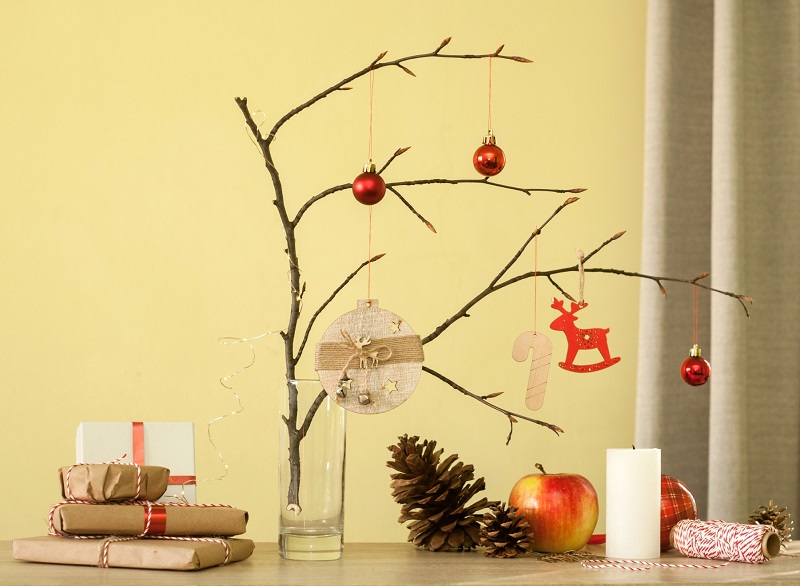 Simple tree branch decorated with Christmas ornaments