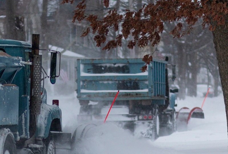 Snow removal salt trucks in residential neighborhood