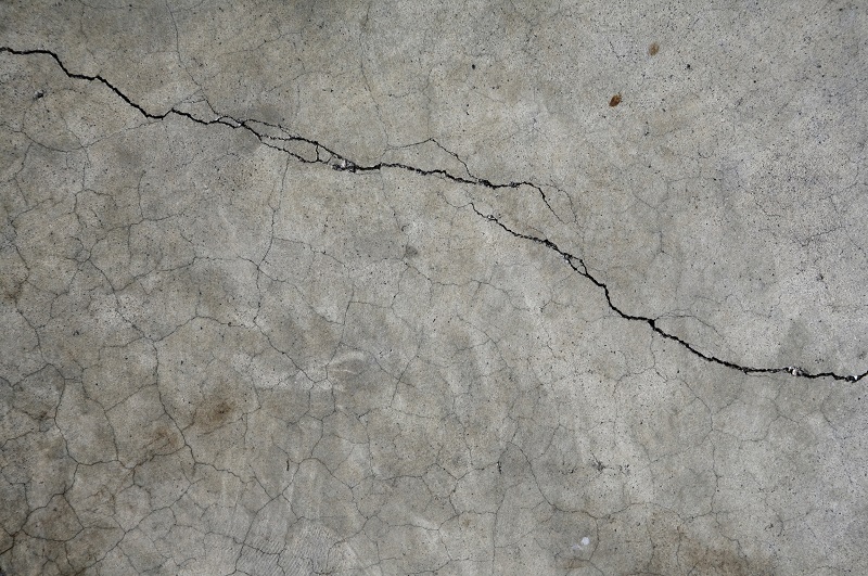Cracked cement surrounding swimming pool