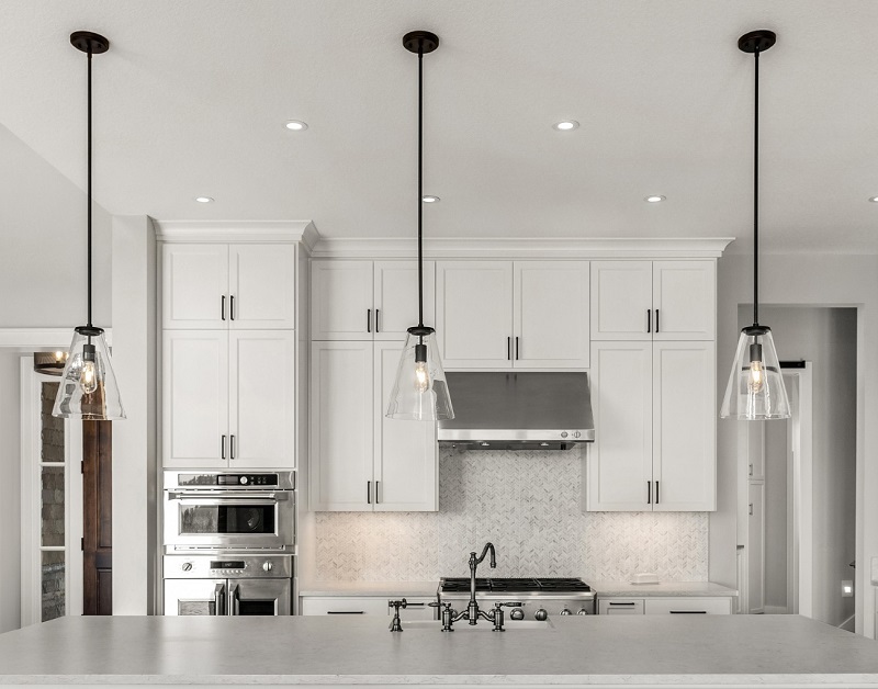 Modern upgraded kitchen with black and glass pendant lighting