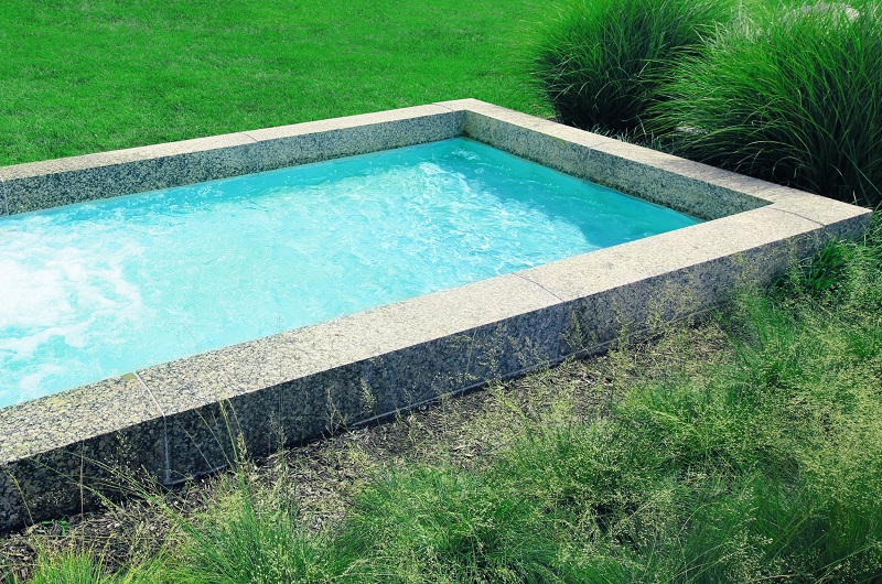Small plunge pool in backyard in natural setting