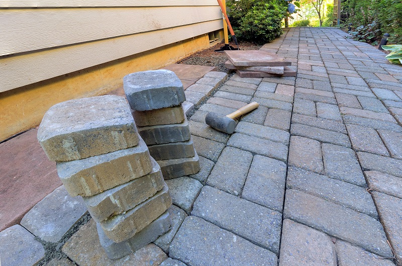 Hardscape sloping away from the perimeter of a house