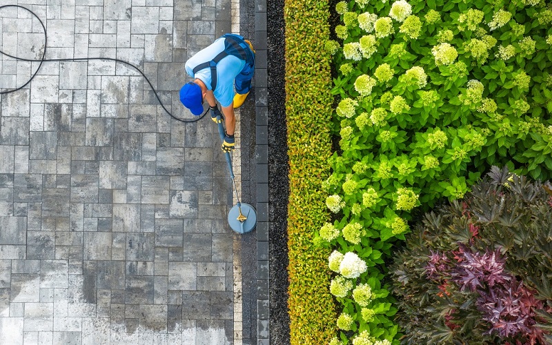 Aerial view of stone driveway with lush, bordering landscaping