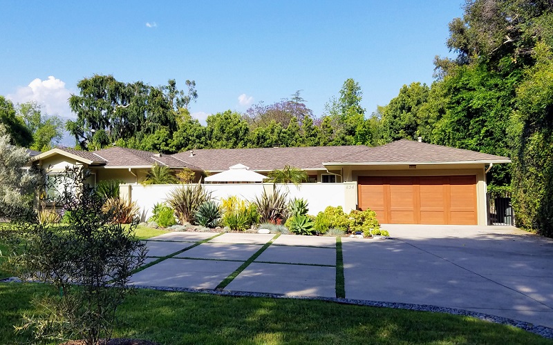 Home with wide driveway with strips of grass for drainage