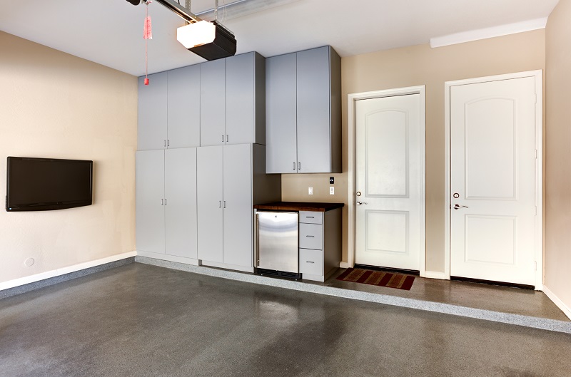 Renovated garage with kitchenette and wall-mounted TV screen