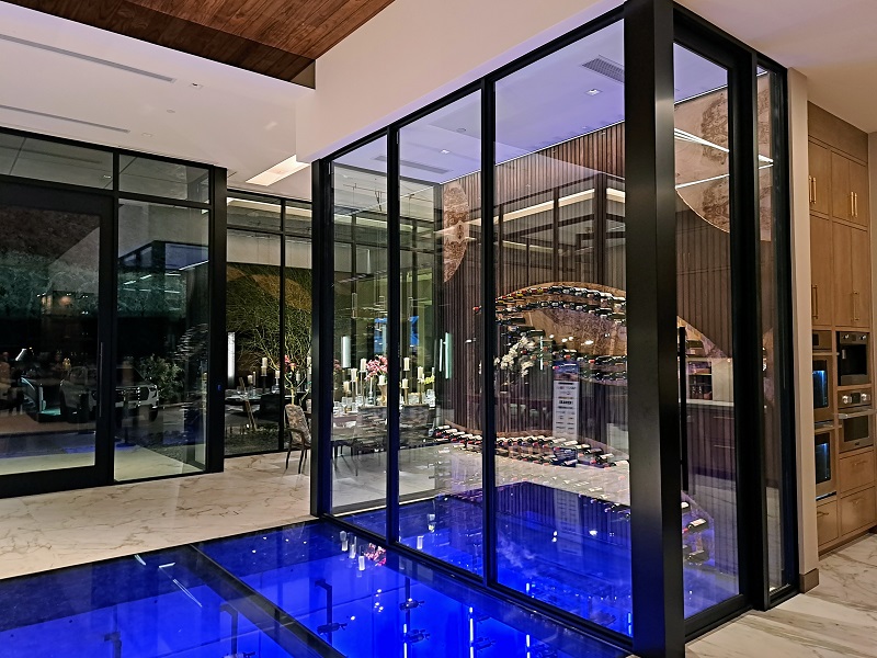 TNAH 2025 basement wine cellar with acrylic floor/ceiling and main floor glass enclosed wine cellar