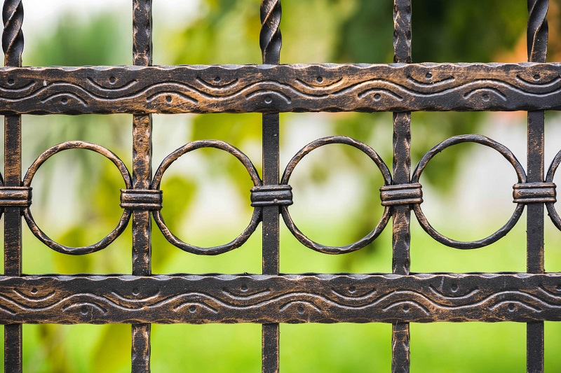 Classic wrought iron fence close up view in front yard