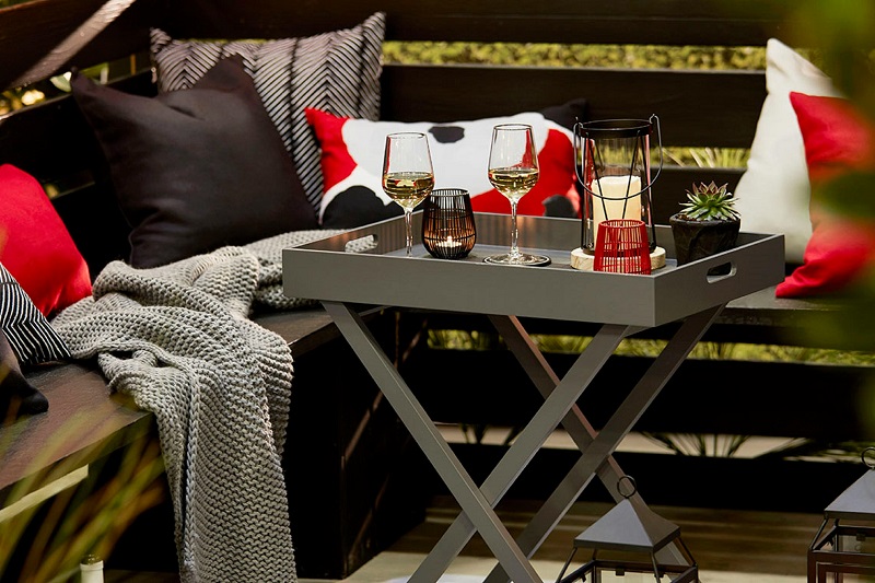 Wine glasses on table near pillows