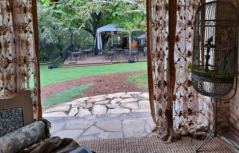 Pasadena Show Case House 2025 Bauer Estate & Gardens: View from La Dolce Far Niente (The Sweetness of Doing Nothing), a covered outdoor resting space designed by Shari Tipich.