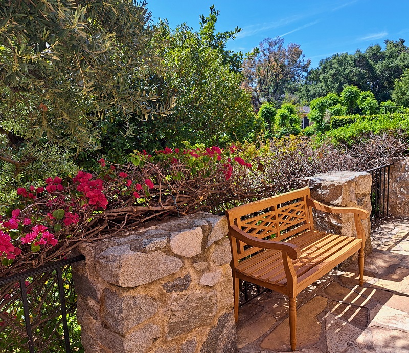 Wooden bench situated on large stone terrace