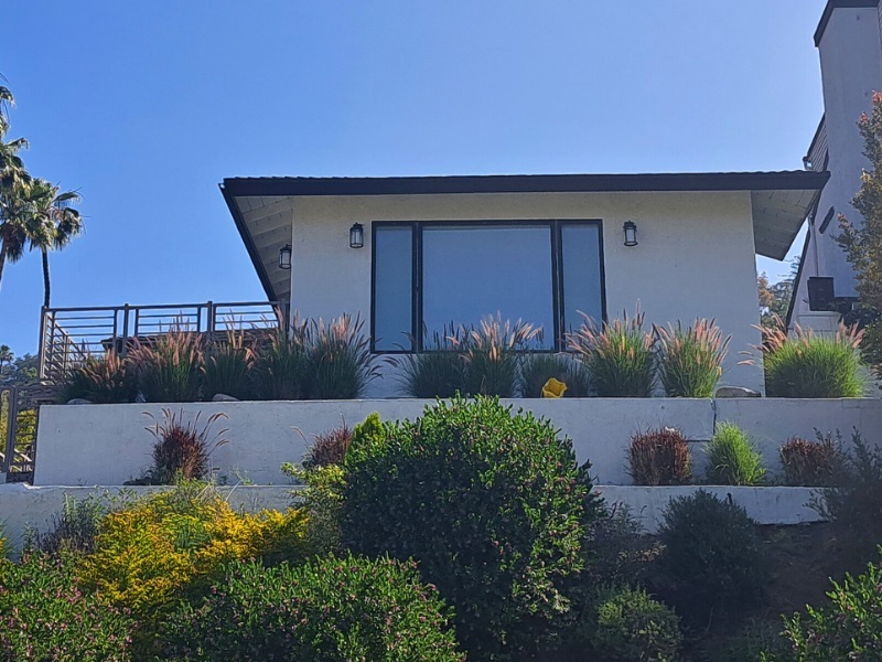 Hillside garden with two retaining walls to stabilize the hillside and provide areas to grow plants