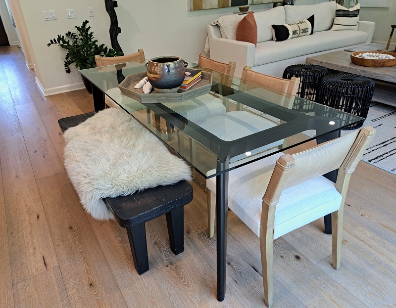 Eclectic dining table and chairs placed between the kitchen and large gathering room