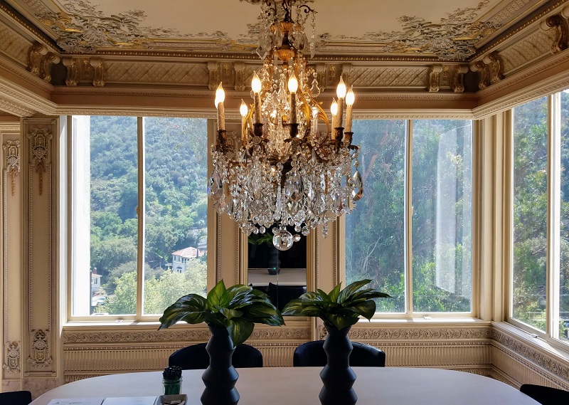 Elegant chandelier surrounded by ornamental molding with a spectacular view