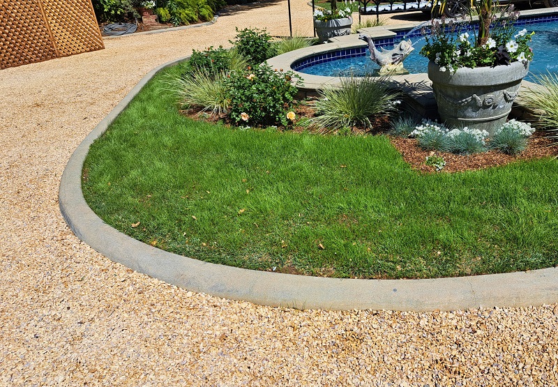 Gravel driveway around large front fountain
