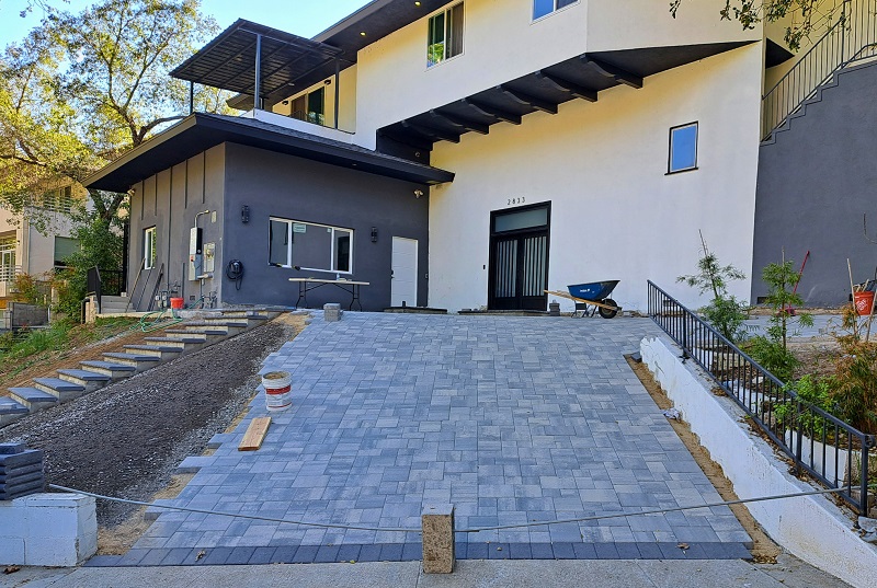 A home undergoing a major remodel installing a paver driveway
