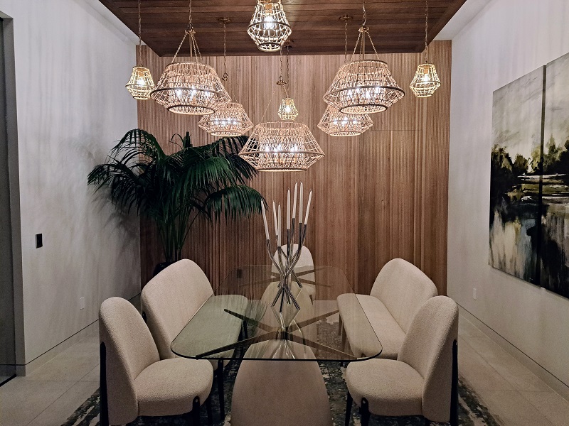Intimate dining room with warm light fixtures wrapped in wood cladding