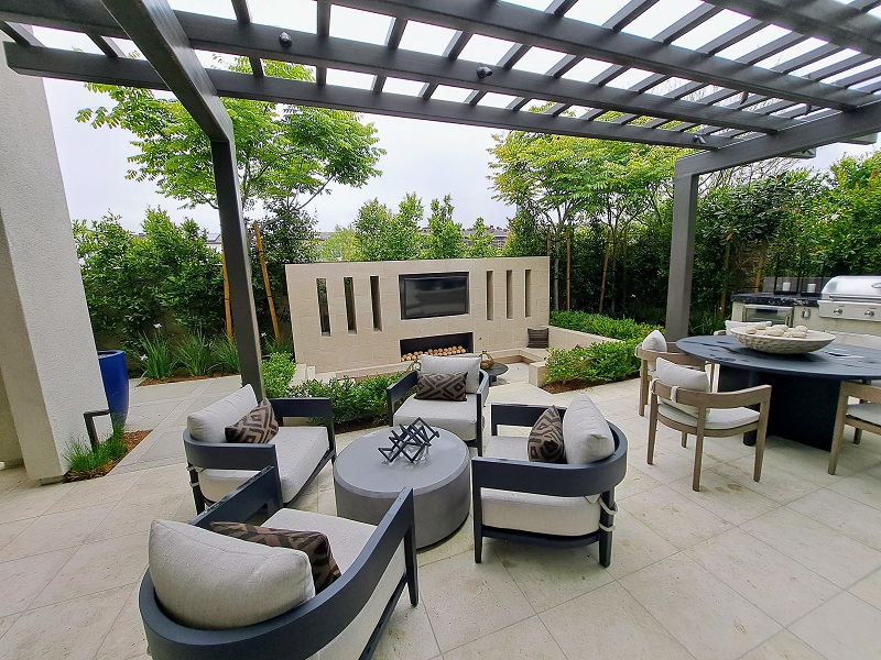 Large patio entertainment area with pergola, outdoor kitchen and ample seating