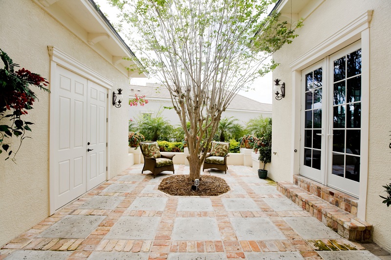 Garden courtyard with cement and brick hardscaping