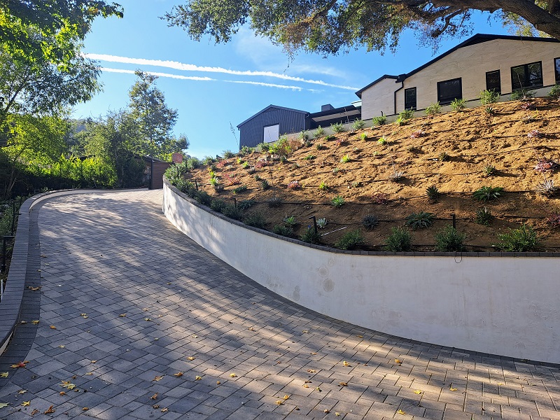 Newly remodeled home with new paver driveway, retaining wall and landscaping