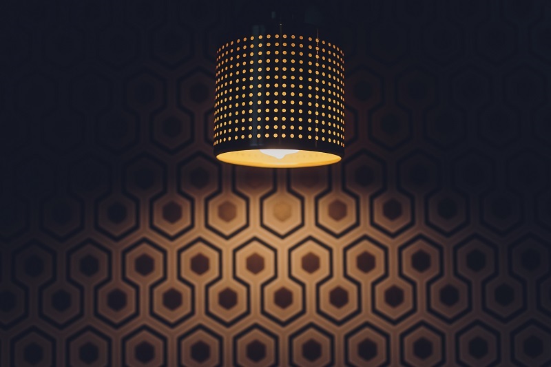 Retro modern copper pendant light in darkly lit room