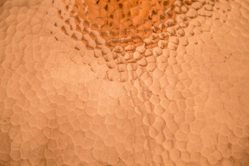 Close up view of shiny hammered copper