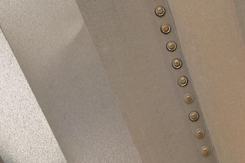Bolts at the seam of a custom metal sculpture