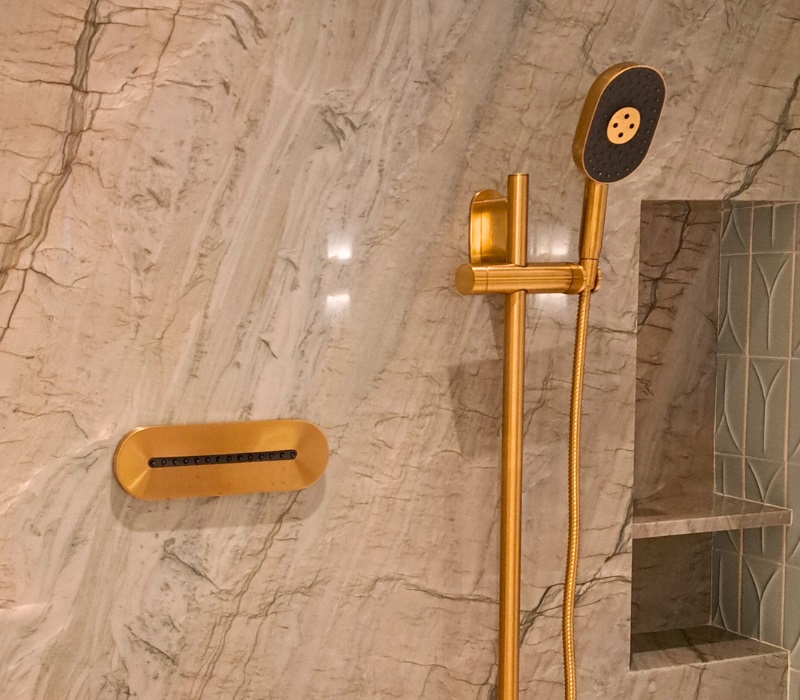 Luxury handheld showerhead fixture in a spacious shower